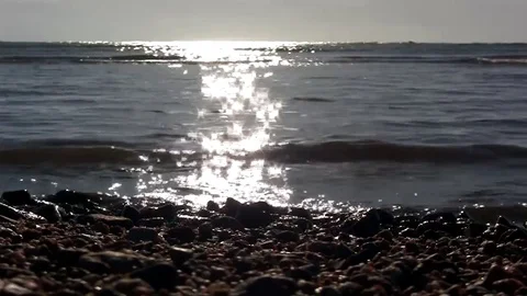 Sunrise twinkle on sea waves low angle Stock Footage 71933380