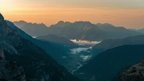 Sunrise in the Valley with lake and clouds, mist Dolomites, Italy 8k Stock Footage 247642889