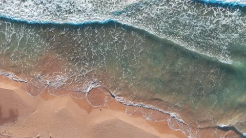 Sunrise view of the beach and waves from above, with light accentuating the.. Stock Footage 283723558