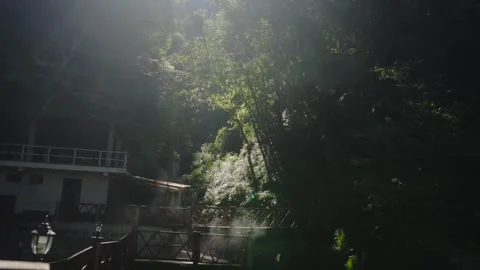Sunrise view between mountains and forest, with sunlight beginning to illuminate Stock Footage 293653130