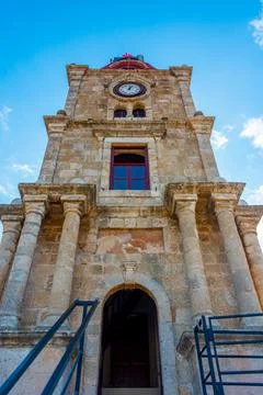 Sunrise view of medieval clock tower in Greek town Rhodes Stock Photos