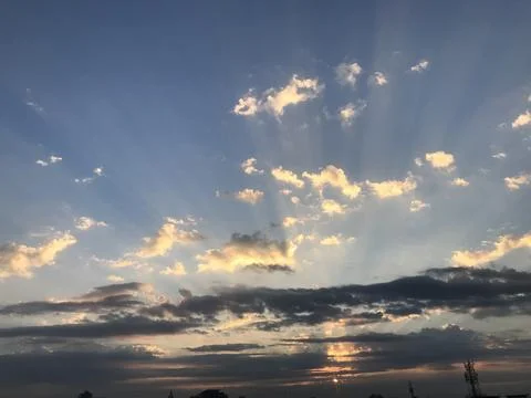 The sunrise view with rays of the sun in the sky Stock Photos