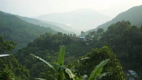 Sunrise on a village in the middle of the mountains surrounded by forest Stock Footage 194494635