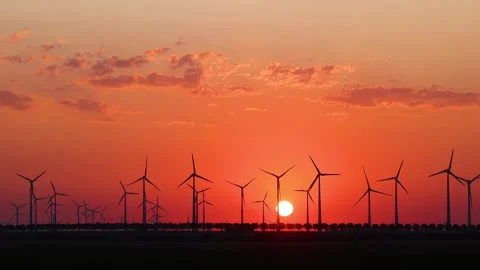 Sunrise at the wind farm. Many wind turbines are turning in the morning light. Stock Footage 313302680