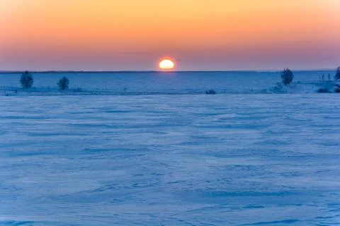 Sunrise in winter in the field Stock Photos