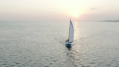 Sunrise yatch, exposing the sun with a slow drone panning shot Stock Footage 143037643