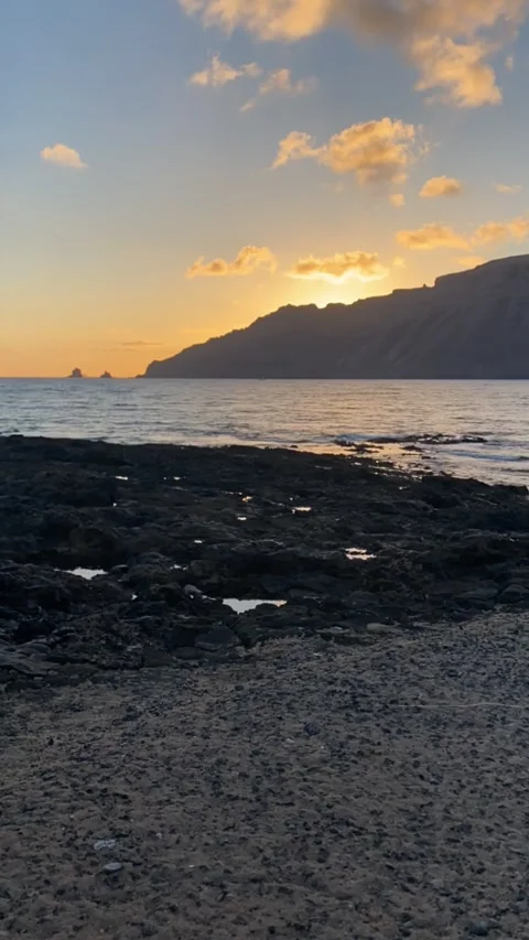 Sunrize over the Risco de Famara view from La Graciosa island Stock Footage 310476570