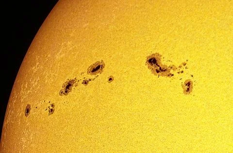 Sun's active surface showing multiple prominent sunspots. Stock Photos