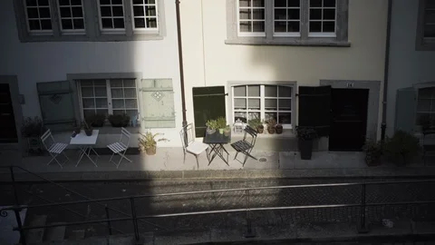 Suns light streak shines on empty table with chairs Stock Footage 127849500