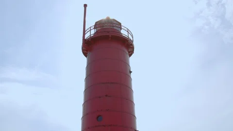 Suns peeks out above the lighthouse at Pere Marquette in early spring, 4k60p Stock Footage 128851791