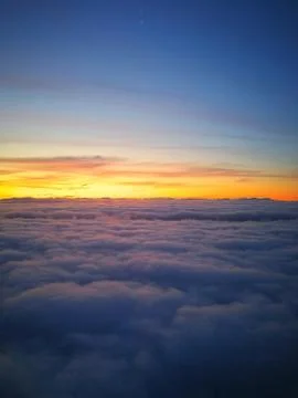 The sun's rays above the horizon from the clouds. Photos from the aircraft's Stock Photos