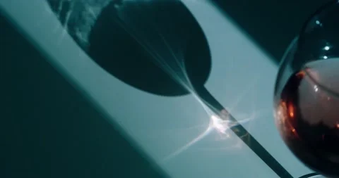 The sun's rays are refracted through a wine glass Stock Footage 186726041