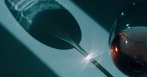 The sun's rays are refracted through a wine glass Stock Footage 186727016