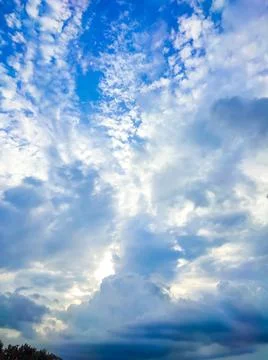 The sun's rays break through the dark clouds in the sky. Beautiful spectacula Stock Photos