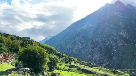 The sun's rays break through mountain ranges and clouds Stock Footage 276426573