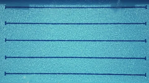 The sun's rays dance on the sparkling water of the sports pool, creating a Stock Footage 247138813