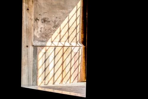 Sun's rays fall into the window through the iron lattice Stock Photos