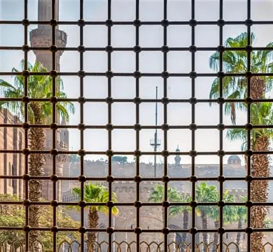 Sun's rays fall into the window through the iron lattice Stock Photos