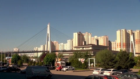 Sun's rays on high-rise buildings behind pedestrian bridge. Stock Footage 106799609