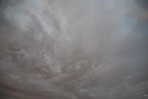 The sun's rays illuminate the sky with clouds. Stock Photos
