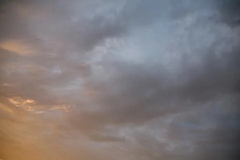 The sun's rays illuminate the sky with clouds. Stock Photos