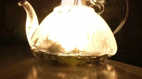 The sun's rays illuminate the transparent teapot. The process of brewing tea Stock Footage 172059581