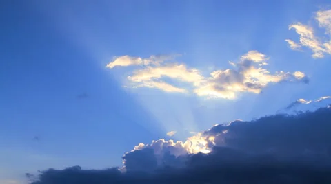 The sun's rays make their way through storm clouds and illuminated flying clouds Stock Footage 28381907