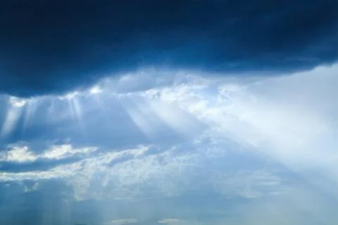 The sun's rays make their way through the clouds. Stock Photos