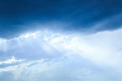 The sun's rays make their way through the clouds. Stock Photos