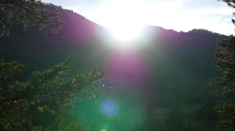 The sun's rays over the mountain river Видео 65993963