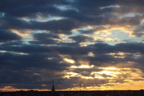 The suns rays pass through the dark clouds. Beautiful dramatic sky at sunset or Foto stock