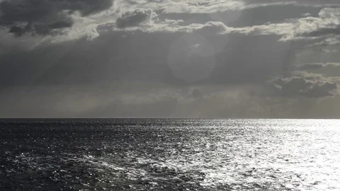 The sun's rays pass through the rain-laden clouds Stock Footage 83542879