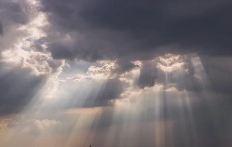 The sun's rays passing through the clouds and shining. Stock Photos