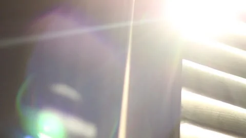 The sun's rays shimmer in the blinds close up panoramic shot Stock Footage 202213292