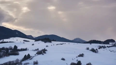 The sun's rays shine through the dense clouds on the snowy landscape Stock-Footage 171993363