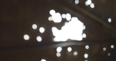 The sun's rays shine through the holes of many bullets. Ver 1 Stock Footage 118546877