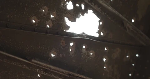 The sun's rays shine through the holes of many bullets. Ver 3 Stock Footage 118547327