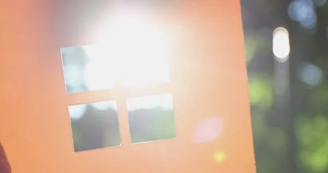 The sun's rays shine through a small window of a paper house. Stock Footage 158666865