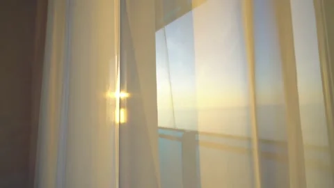 The sun's rays shine through the transparent tulle or curtains. Video stock 171589389