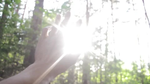 The sun's rays through the fingers of his hand Stock Footage 91086492