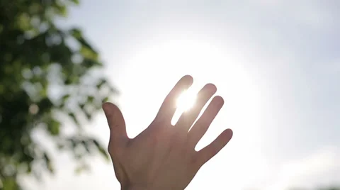 Sun's rays through fingers palm. Male. Slow motion Stock Footage 38580526