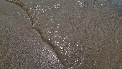 The sun's reflection in the water. Sandy beach with waves. Stock Footage 262430519