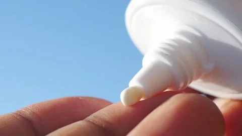 Sunscreen application at the beach in bright sunlight Video stock 311426061