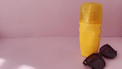 Sunscreen bottle with sunglasses for summer holidays and travel, showing sk.. Stock Footage 334617420