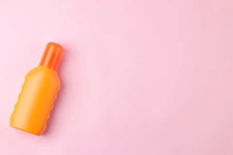 Sunscreen on a bright pink background. summer. vacation. top view. space for Stock Photos