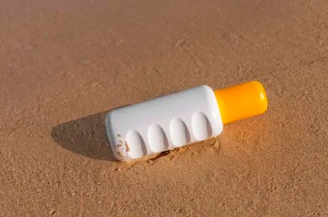 Sunscreen cream bottle on the beach Stock Photos