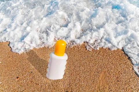 Sunscreen cream bottle on the beach Stock Photos