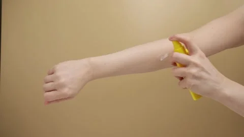 Sunscreen on hands, SPF application, sunblock protection, outdoor skincare Video stock 269359088