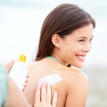Sunscreen lotion on beach Stock Photos