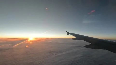Sunset above the clouds - from passenger airplane window Video stock 220875206